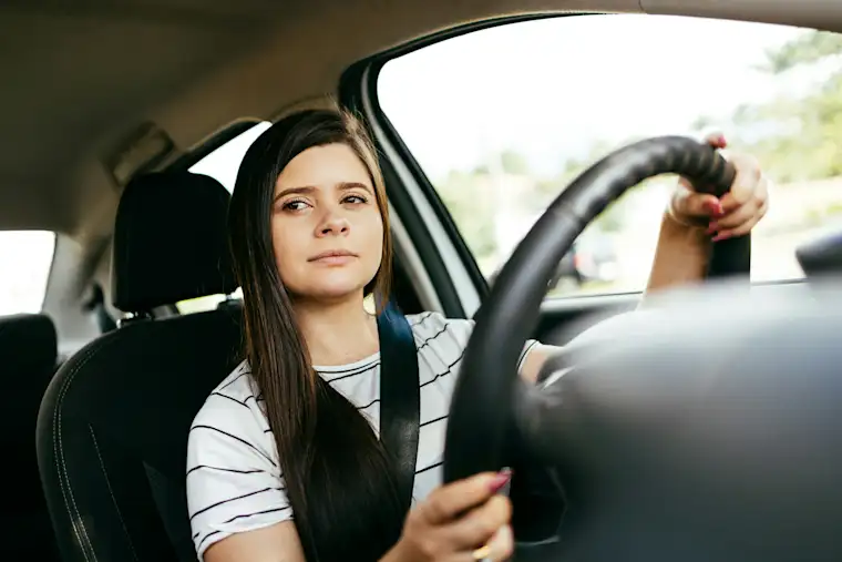 Young woman riding a car