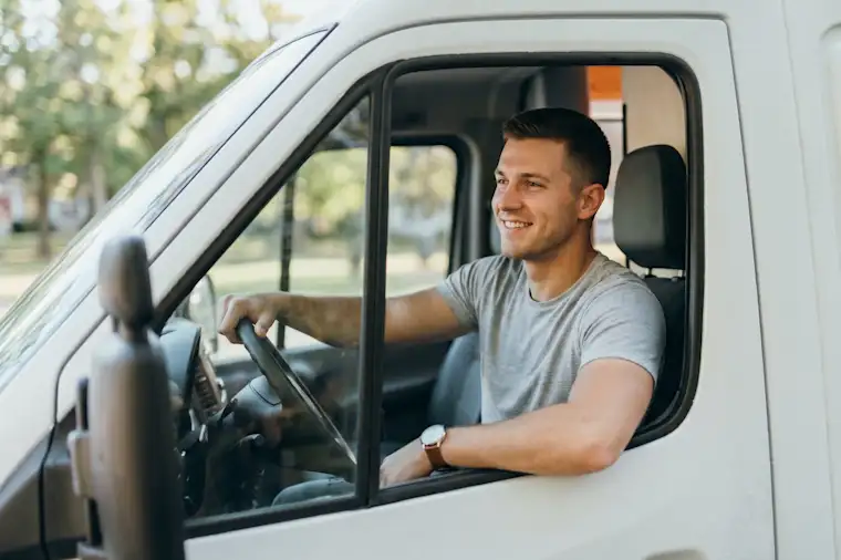Man behind steering wheel of a van