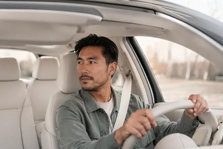 Front view image of a man driving car