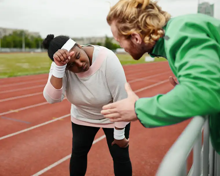 Beauty Wellbeing And Sport - Landscape - Running Coach - Hero - Coach Talking to a client on running path