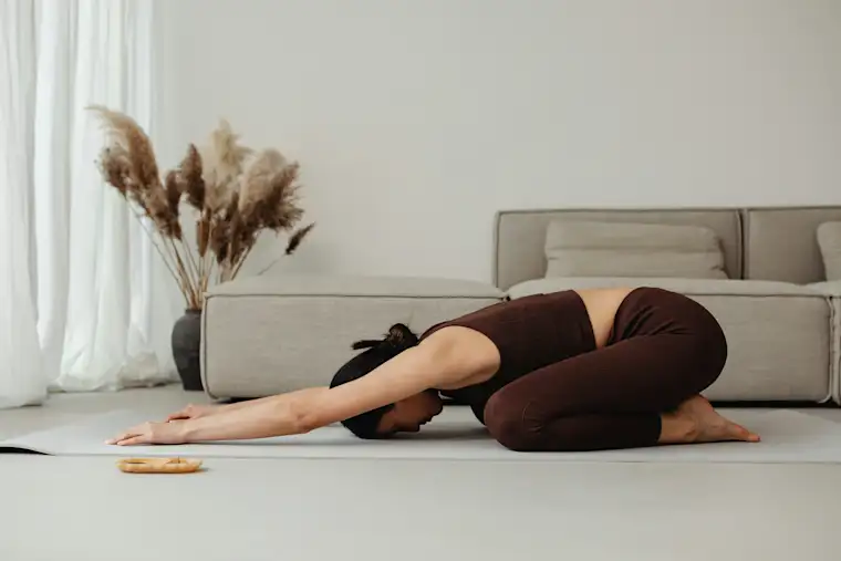 Beauty Wellbeing And Sport - Landscape - Yoga Instructor - Action - Woman in childs pose at home