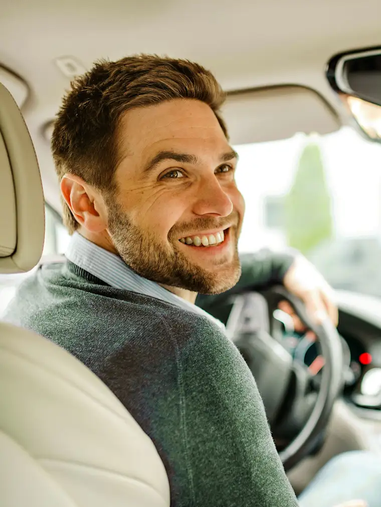 Man looking back in a front seat in car