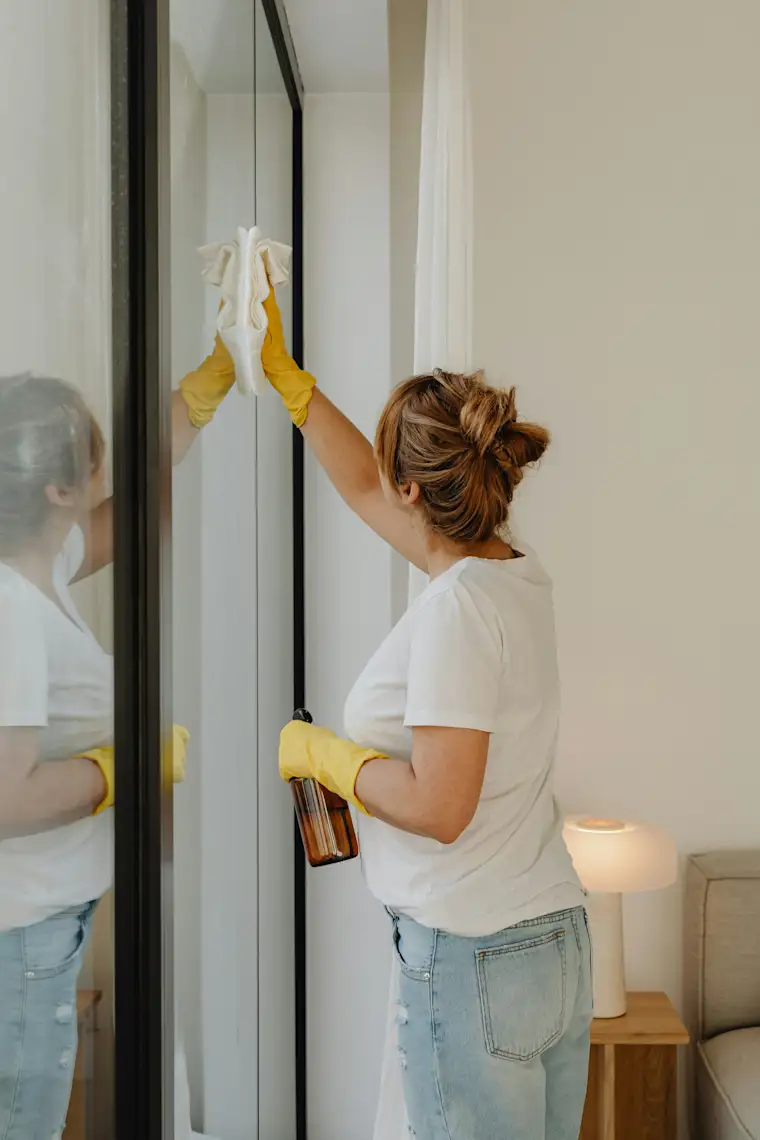 Cleaning - Portrait - Woman wiping window