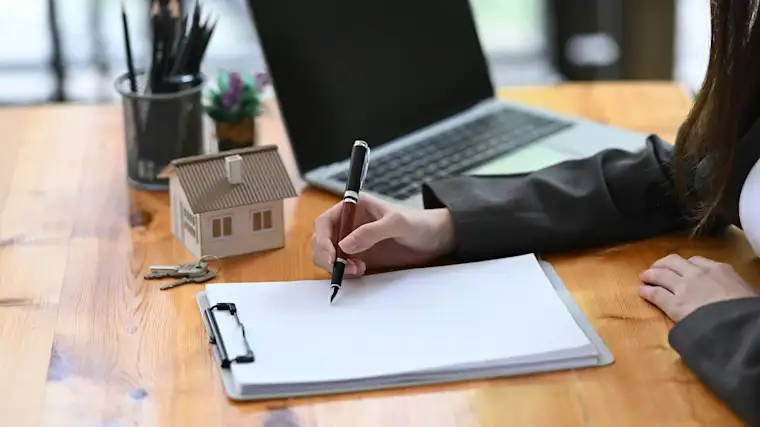 Real Estate Agent - Pen on paper