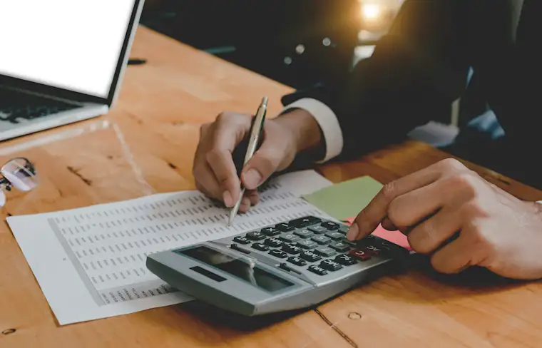 ALL - Generic - Landscape - A person calculating the costs on calculator