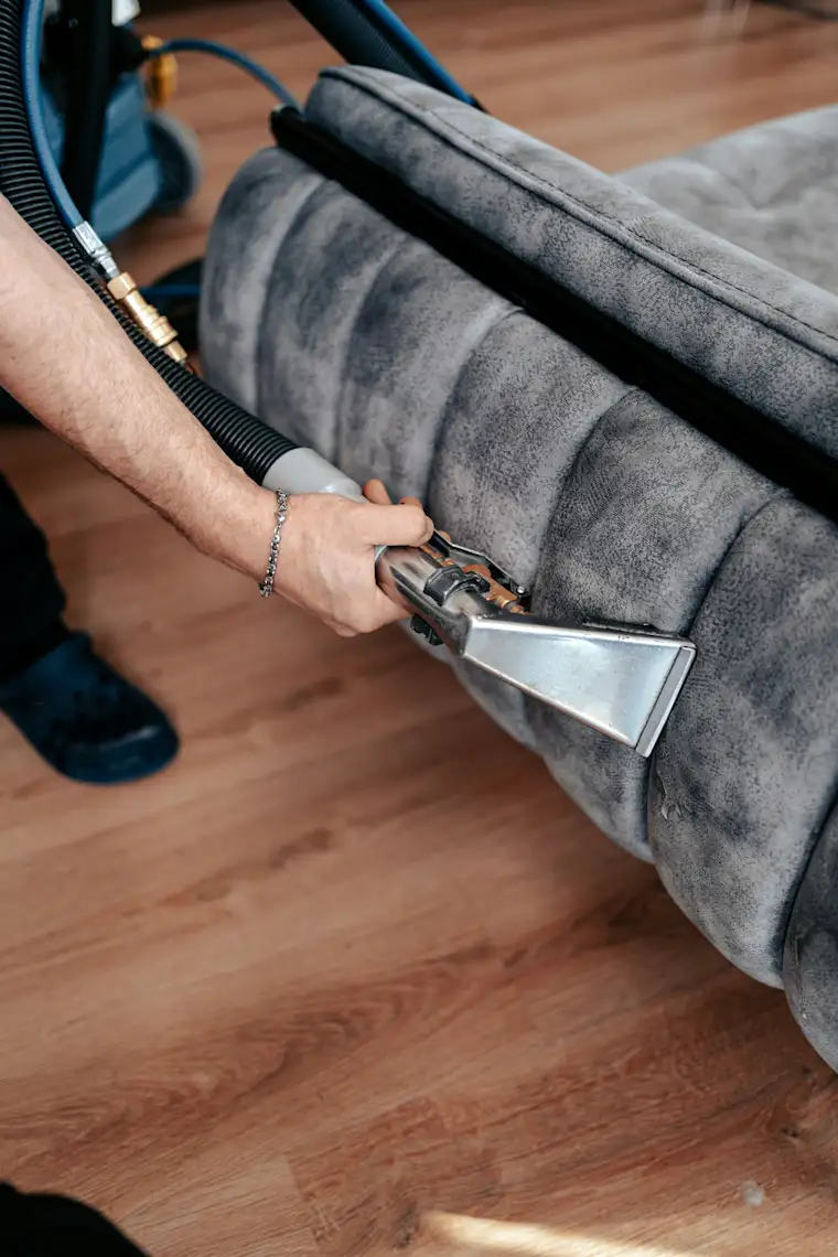 Cleaning - Portrait - Vacuuming Sofa