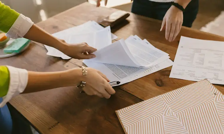 ALL - Generic - Landscape - Lawyer handing documents to a person to sign
