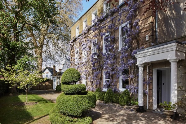 Outside shot of a wisteris-covered, Georgian-style home in Surrey