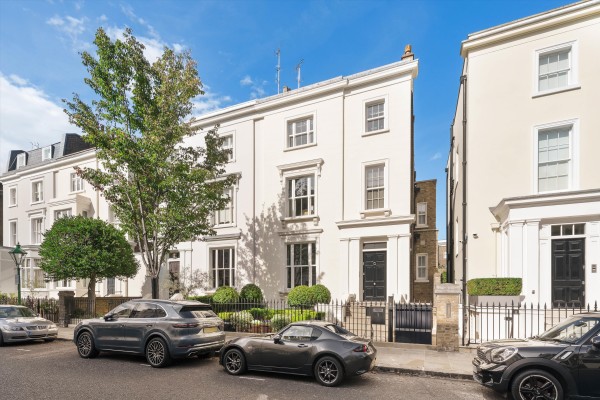 A large semi-detached white stucco-fronted family home in Kensington
