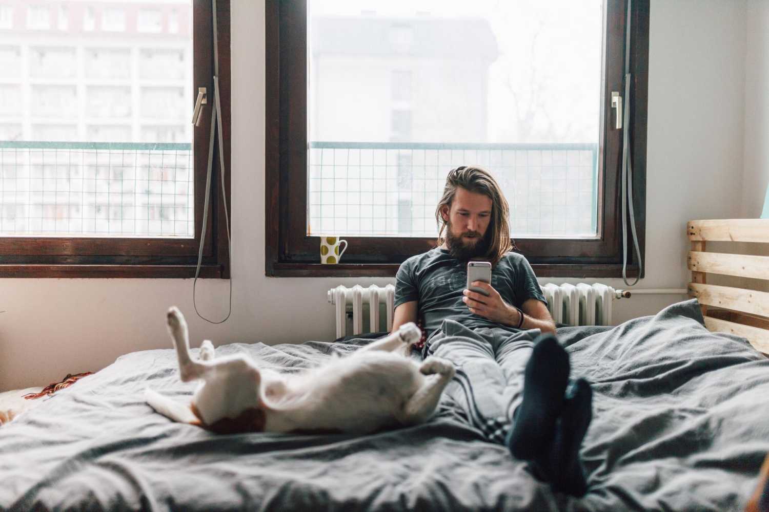 Man with dog on bed