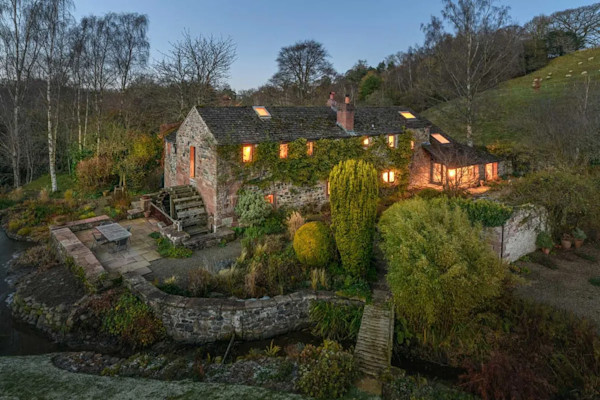 Aerial evening view of a restored water mill for sale in Carlisle, Cumbria: £950,000 guide price