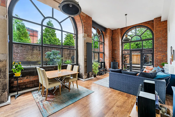 Double height reception room at a triplex for sale in historic mill conversion in Bolton