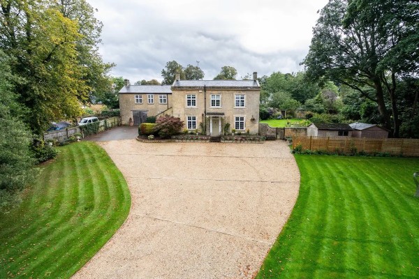 Outside aerial shot of a detached, Georgian-style country home in Chipping Norton