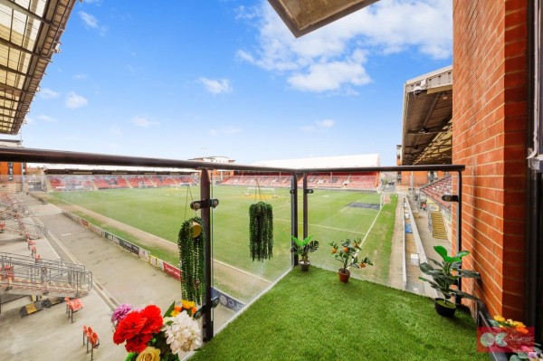 The balcony of the 2 bedroom London flat with Leyton Orient's football ground in the background. The balcony has astro turf on the floor and glass railings so you could sit and watch football matches with an uninterrupted view.
