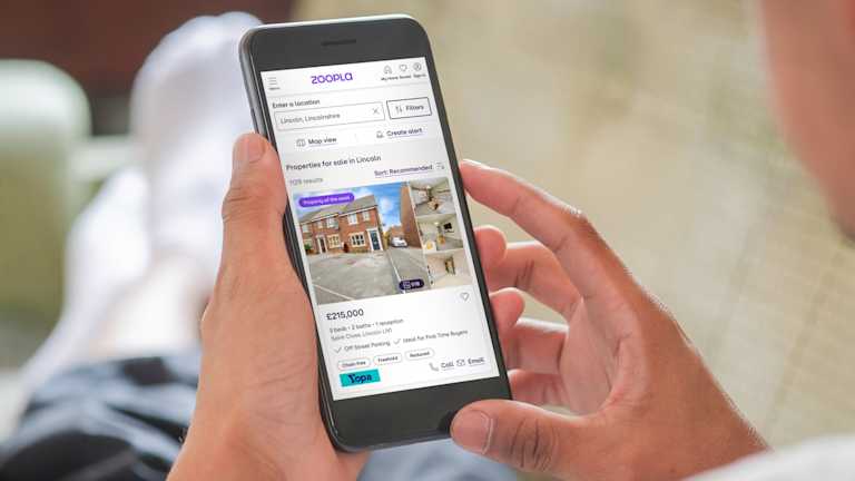A mobile phone showing someone searching houses for sale on Zoopla