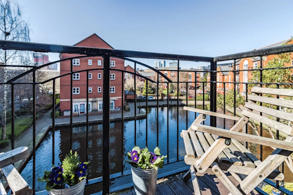 The view from a balcony in Manchester overlooking a pond