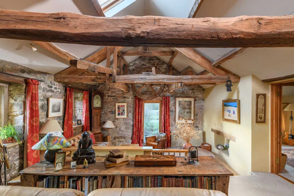 The cosy and characterful reception room of a converted water mill for sale in Carlisle, Cumbria