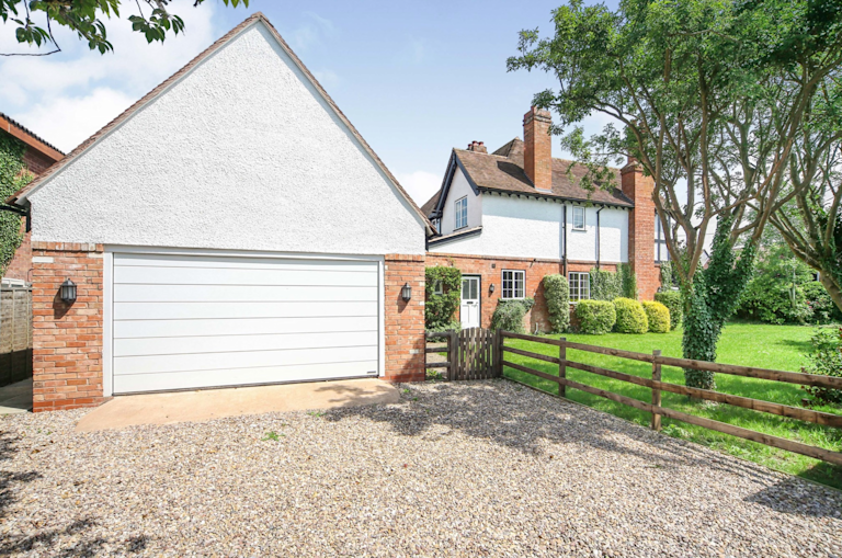 A home with a detached garage and driveway