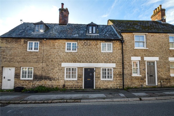 The exterior of a cute terraced cottage set close to the street in Swindon town centre