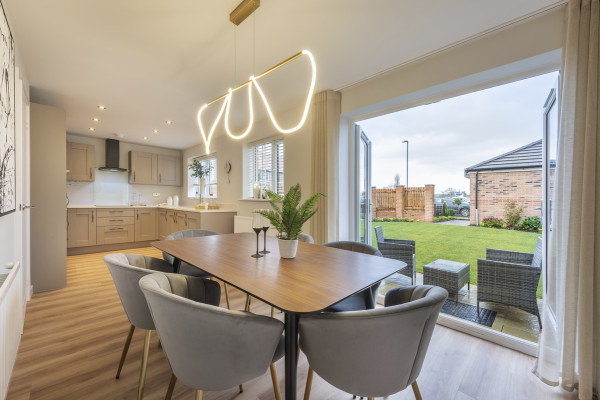 A large and modern kitchen/dining room in light colour scheme with French doors to the garden