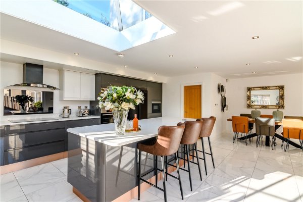 The stylish kitchen of the eco-home in Yorkshire, with a skylight and breakfast bar and stools