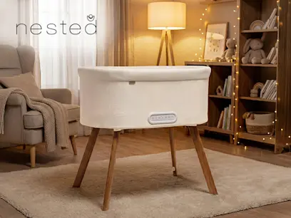 Nested Motion Electric Bedside Crib on the indoor bakcground