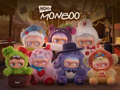 "HOHO-MONBOO" logo above seven plush collectible figures in colorful animal costumes, including green, pink, purple, tan, and white designs, set against a blurred carnival background.