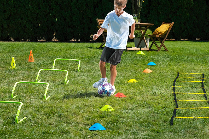 Boredom Busters Blog 9-11 Years Duplex Banners 2 - Image - child playing football drills with cones