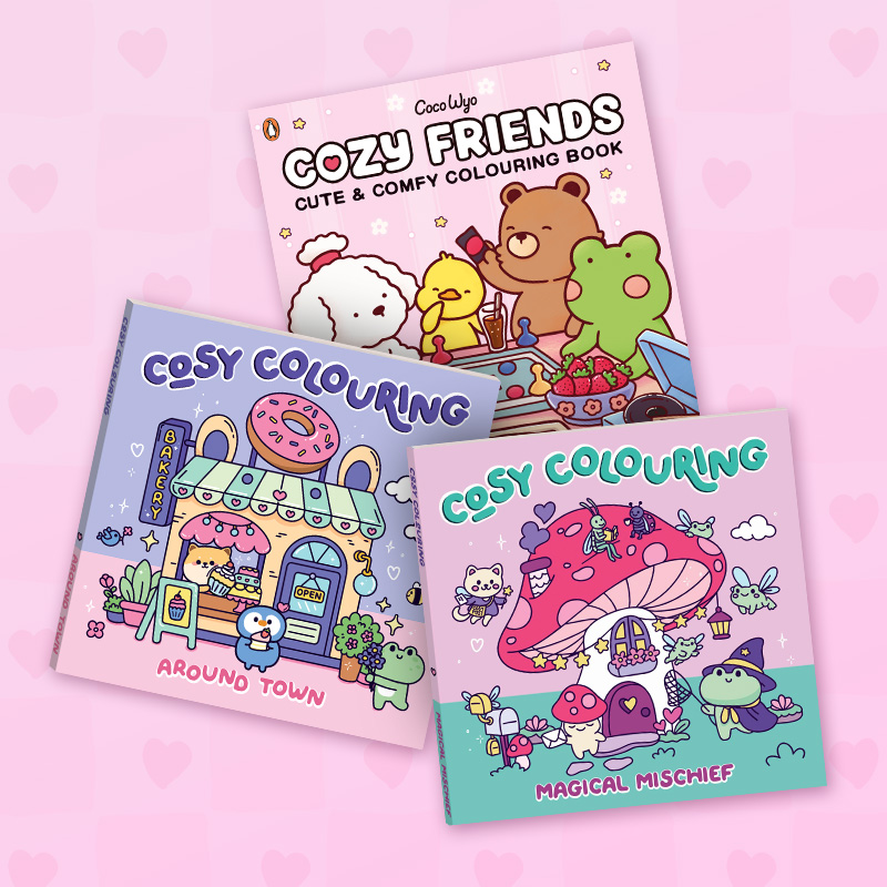 Three pastel-coloured cosy colouring books are displayed against a pink heart-patterned background. Covers feature cute cartoon animals and scenes: a bakery shop, a mushroom house with fantasy creatures, and animal friends playing games together.