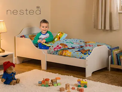 Nested Wooden Toddler Bed White on the indoor cozy background 