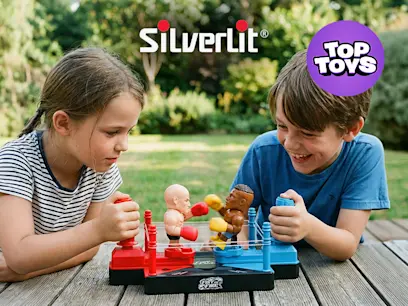Two kids playing the Silverlit Fist On Fire Boxing Robots Set on a wooden table outdoors.