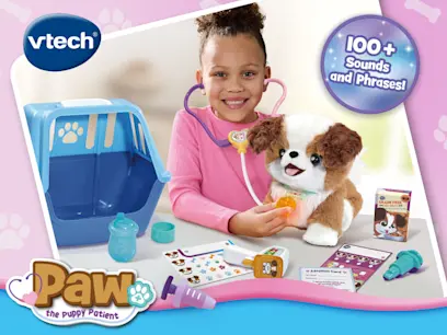 VTech Paw the Puppy Patient toy set showing a child using a stethoscope to examine a plush puppy. The set includes a pet carrier, feeding accessories, medical tools, adoption card and treats, with “100+ sounds and phrases” displayed.