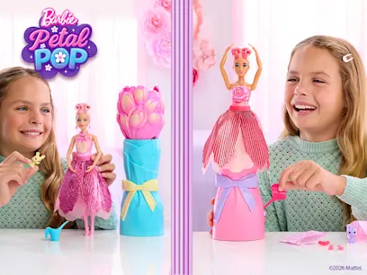 Two girls playing with the Barbie Petal Pop Reveal Dolls in a room.