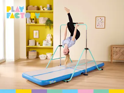 Girl using the Play Factory Gymnastic Bar and Gym Mat Bundle in a brightly lit room. 