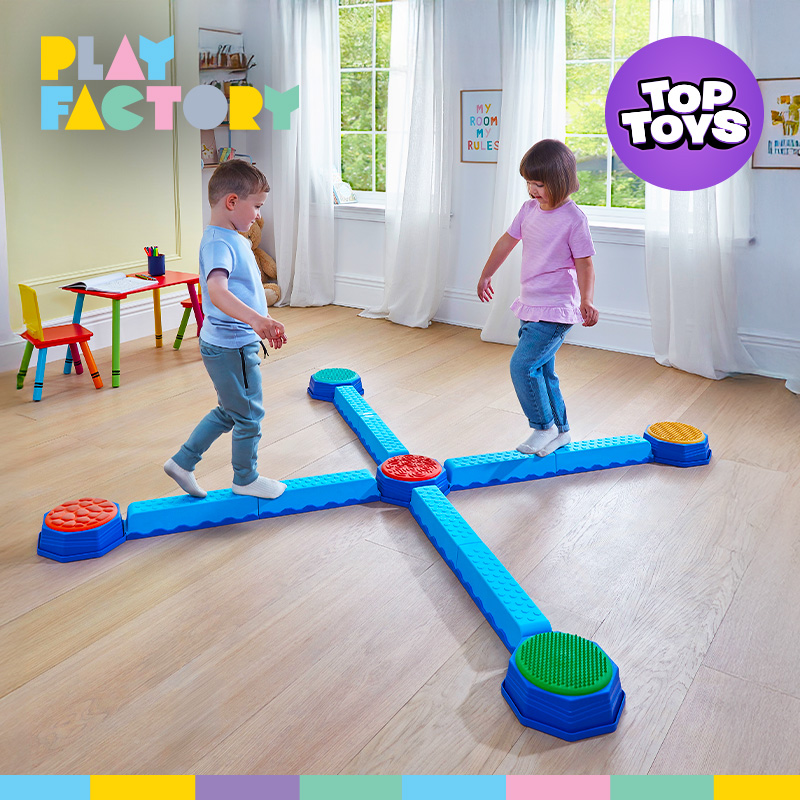 Two kids balancing on the Play Factory Balancing Beam Set on the floor of a bright sunlit room.