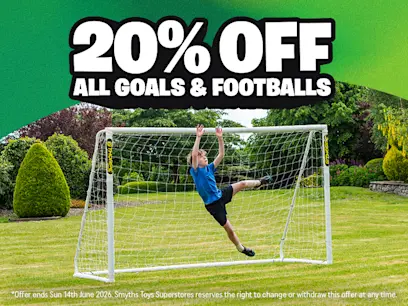 A kid playing football in front of a goal in a garden