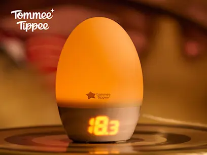 Tommee Tippee GroEgg 2 Nursery Night Light and Thermometer on the indoor orange background