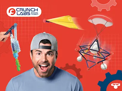 An excited Mark Rober with some of the Crunch Labs products on a red background behind him.