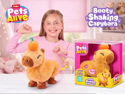 Pets Alive by ZURU Booty Shaking Capybara Interactive Plush and a girl on the indoor background 