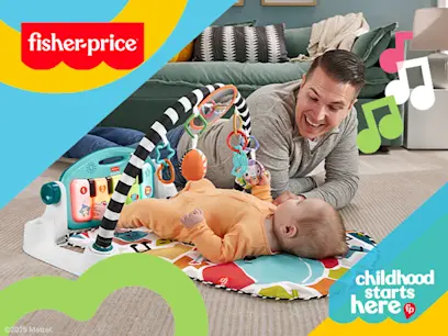 Fisher-Price Glow and Grow Kick & Play Piano baby and dad playing on the floor