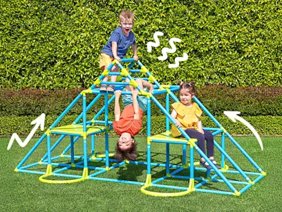 Kids playing outside on the Eezy Peezy Large Pyramid Climber in a green garden.