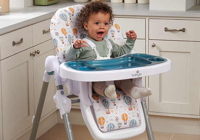 baby sitting in feeding chair