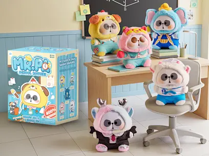 A school-themed display of five cute raccoon-like plush toys in colourful animal outfits, with some sitting on books and a chair. A “Mr. Pa School Routine” blind-box set is shown on the left.