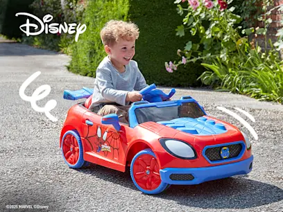 This one features a Disney/Marvel Spider-Man-themed ride-on car, with a child driving a bright red-and-blue convertible outdoors. The Spider-Man branding is prominently displayed on the car.