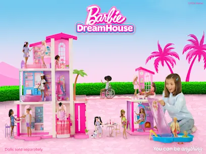 A girl playing with the Barbie Dream Land Dreamhouse Playset