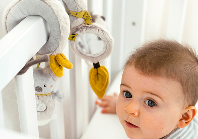 baby with spiral sensory toy