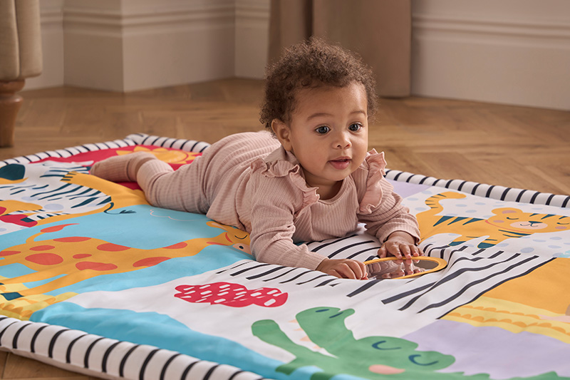 baby on safari play mat