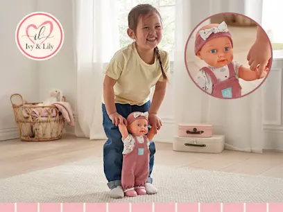A girl holding and playing with the Ivy & Lily Baby Learns to Walk Interactive Doll in a bright room.