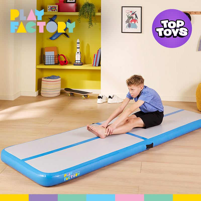 Boy using the Play Factory Air Track Inflatable Gym Mat in a brightly lit room. 