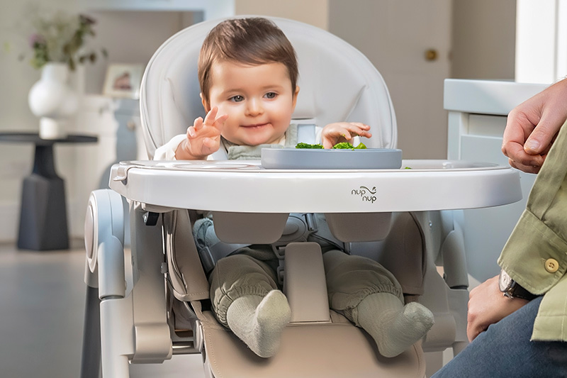 baby sitting in feeding chair